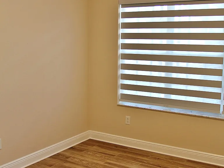 This again is a picture of the sister apartment... just picture this master bedroom with gorgeous hardwood oak flooring. The "new" bedroom Zebra Blinds are Blackout Blinds for your comfort.