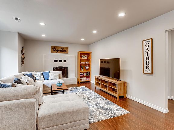 Spacious Living room with big couch and 60" Smart UHD TV