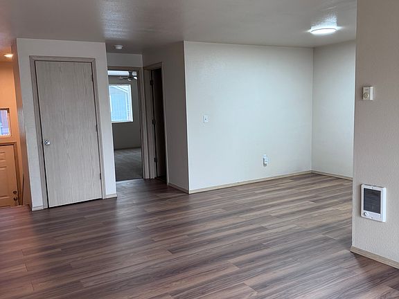 Living room, dining room, coat closet, entry into master bedroom and door into bathroom