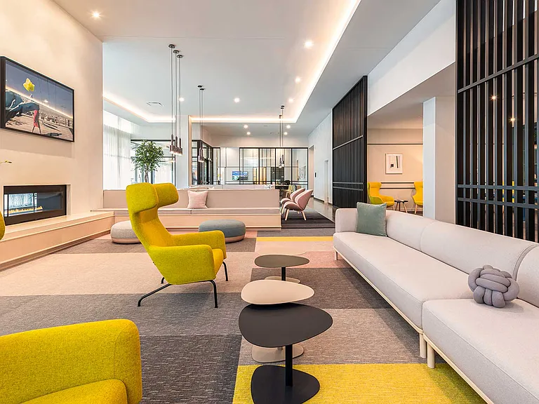 Relax fireside or connect with friends in Eleven33's contemporary lounge a space where bold design and everyday comfort come together beautifully.