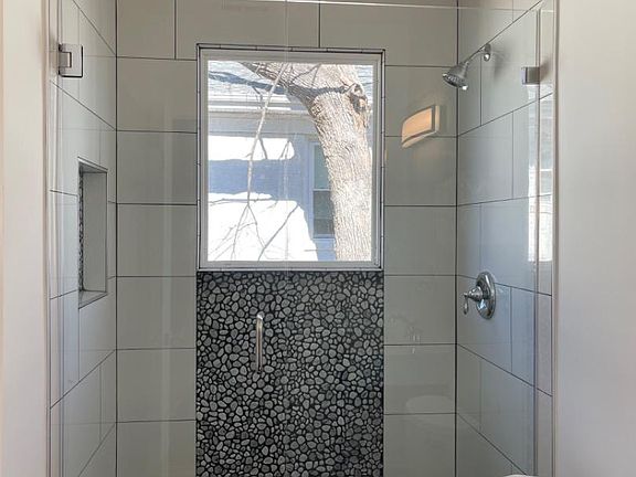 Walk in tiled shower with glass closure