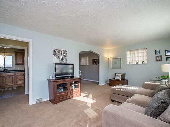 This view of the living area shows the flow of the main level.  Opening to the right leads to the dining room and and opening on