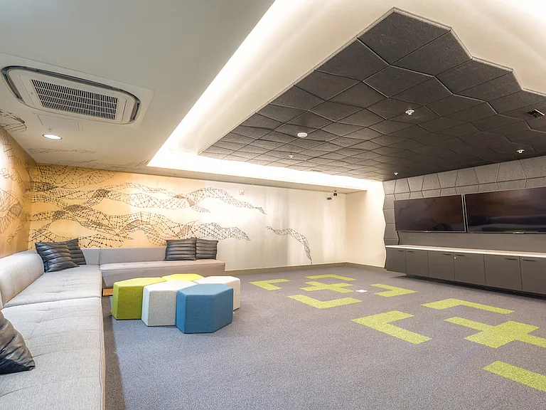 Creative lounge with bold wall art and playful seating.
