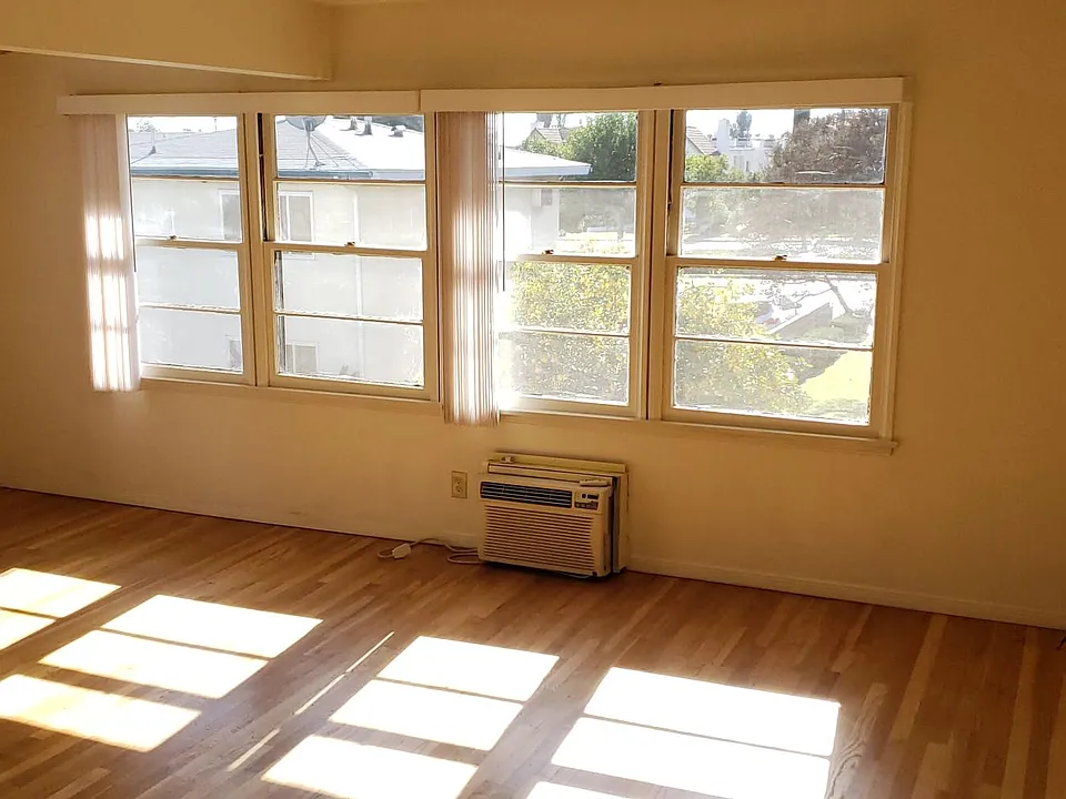 Spacious bright living room with wall mount AC unit