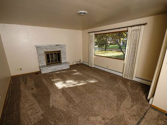 Enter from the front door and step into the living room (20x14) with stone fireplace and large picture window.  Neutral paint and carpet warm the space and provide a backdrop for your personal style.