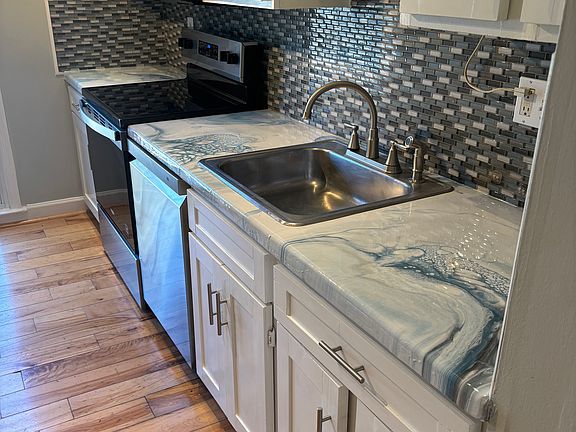 Kitchen with custom epoxy countertops & new appliances
