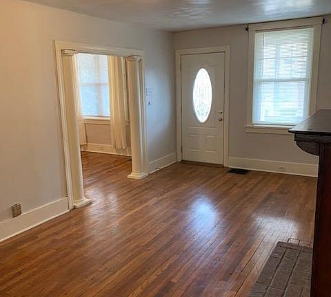 From stairs toward fron door. Great living room!