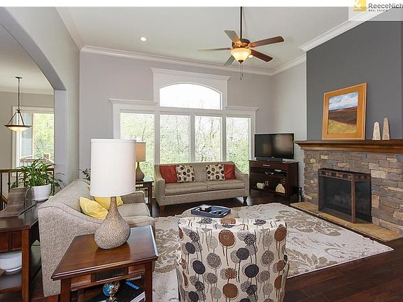 Lovely stone fireplace in great room with accent paint.