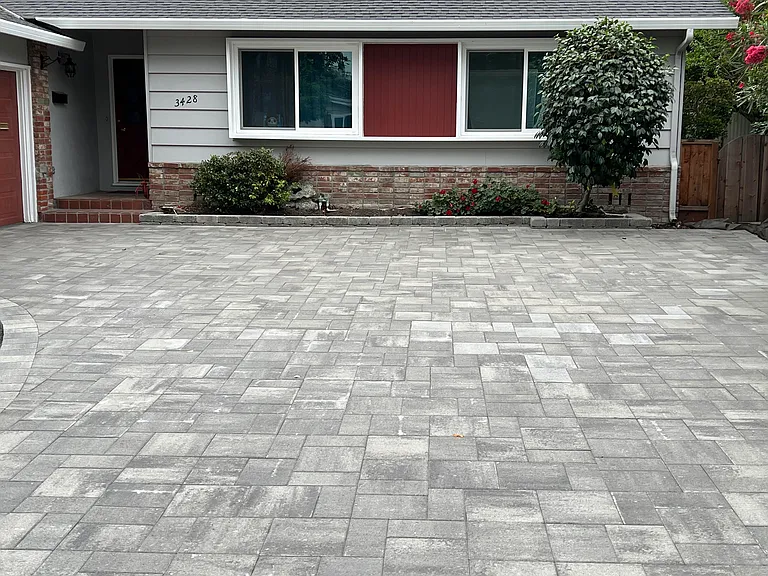 Spacious driveway with new pavers; Bedrooms 2 & 3 feature upgraded windows overlooking the front yard