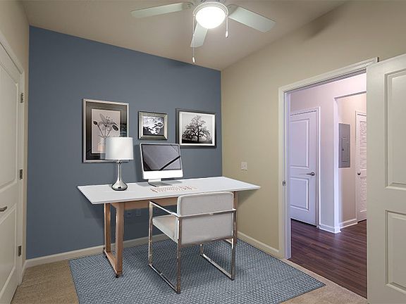 Carpeted workspace area with accent wall