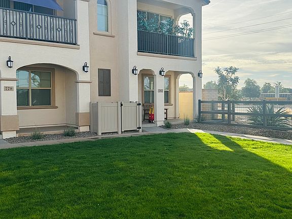 End unit with lush greenbelt in front of home.