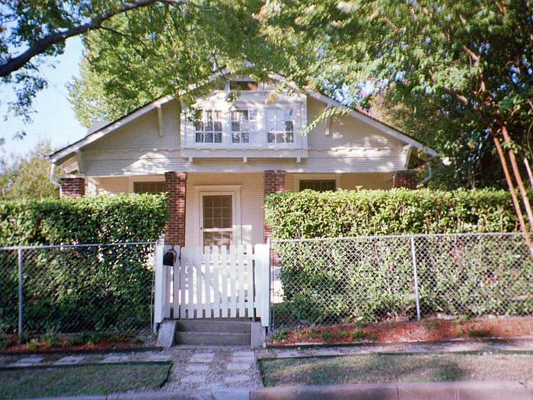 View of arbored trees over entire house both front and back and sides, The yard hosts fully fenced space with professional landscape with outdoor lighting. Walk paths throughout the garden area. Plenty of space for play and garden enjoyment surround th