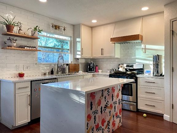 Full of light kitchen with plenty of storage, appliances and granite countertops