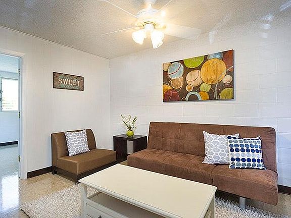 living room with furniture prior to new floor installation
