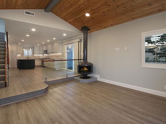Open living room with, vaulted ceilings, upscale design and Swedish Stove
