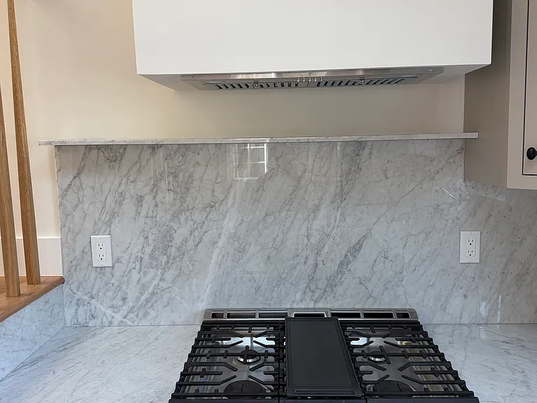 custom hood and marble shelf
