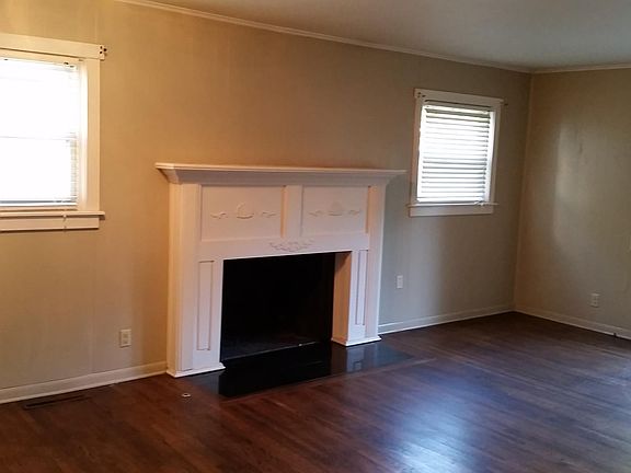 Living area with hardwood floors and access to deck.