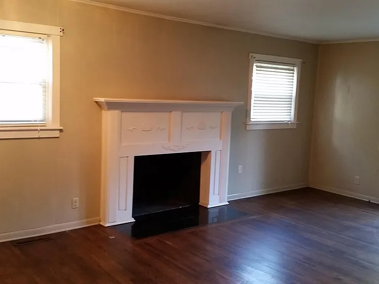 Living area with hardwood floors and access to deck.