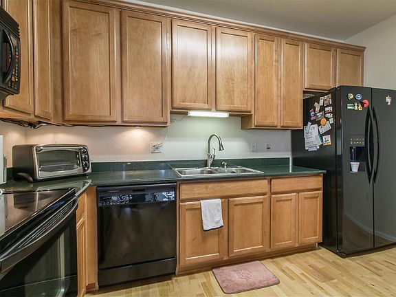 Spacious kitchen with stone counters and plenty of cabinet space.  Wood Floors.