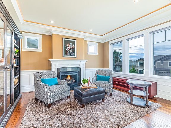 Another view of the formal living room, anchored by gas fireplace