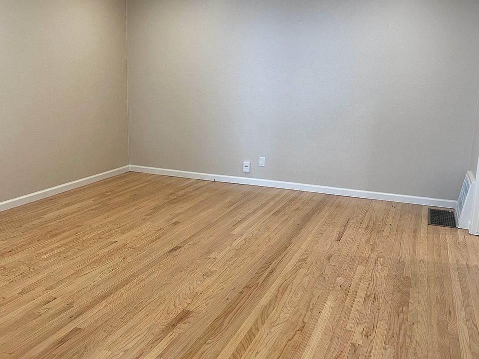 VIEW OF LIVING ROOM WITH CAN LIGHTING & REFINISHED HARDWOOD FLOORS.