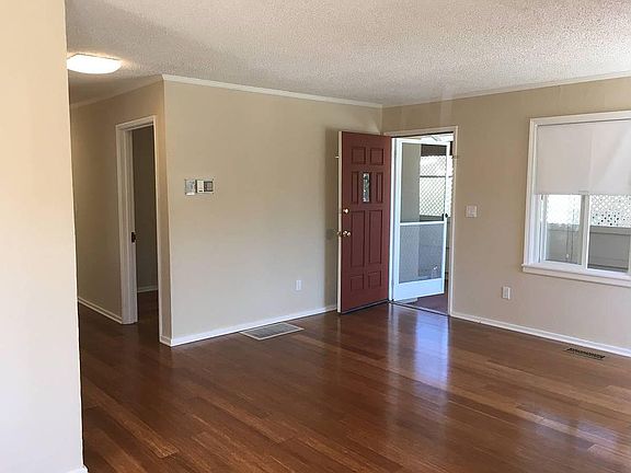 view from living room to front door. bedroom hallway on the left. bamboo hardwood floors