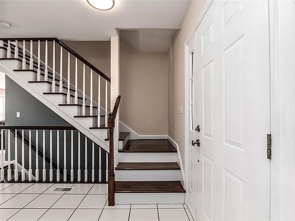 Beautiful open staircase leading upstairs with stained wood steps