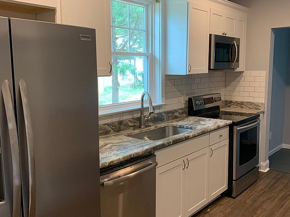 Brand new kitchen with granite, stainless steel appliances and new flooring.