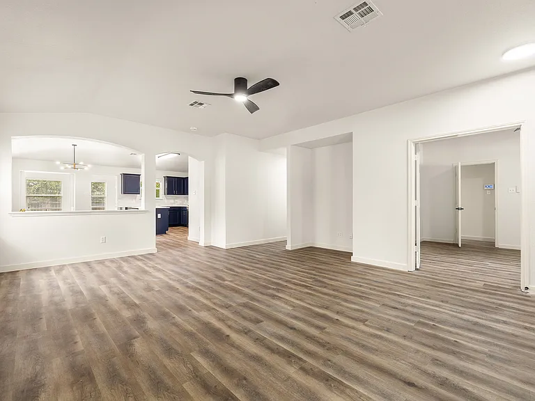 Large open living room over looking the dining area and kitchen