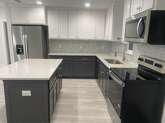 Kitchen with all new Whirlpool Gold appliances. Island includes USB and USB-C ports for charging your electronics.