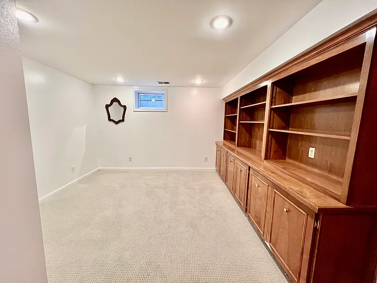 Den in basement, with built-in bookshelves. Lots of options for this room: a game room, extra guest room, or a home office.