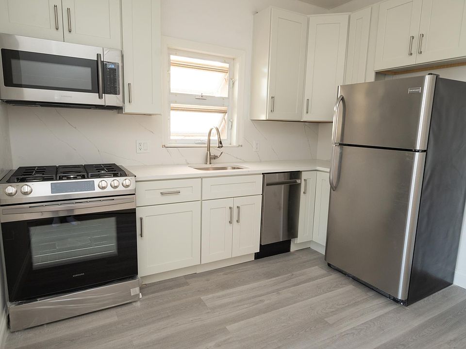 Brand new gut renovated kitchen - complete with dishwasher, under cabinet lighting, high end light fixtures, marble look quartz counter tops, etc