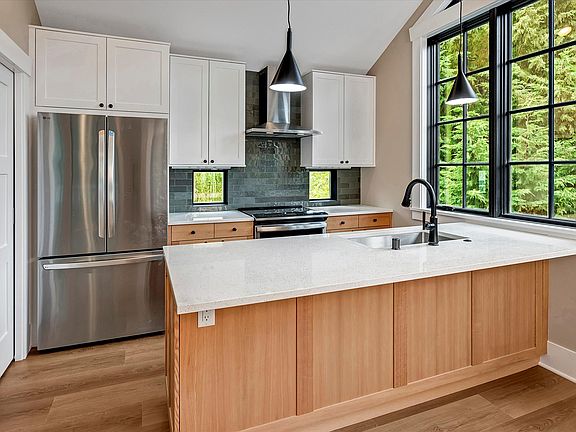 A kitchen that looks out on green! High ceilings throughout.