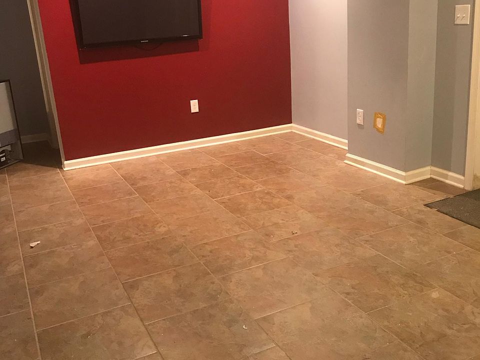 Large open-pan living room area with tile floor; view from t