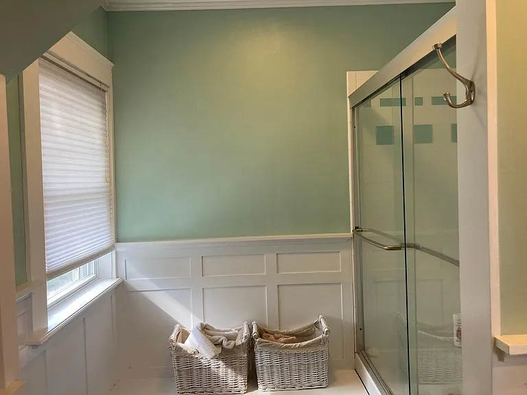 Bathroom featuring built-in bench and shower with tub
