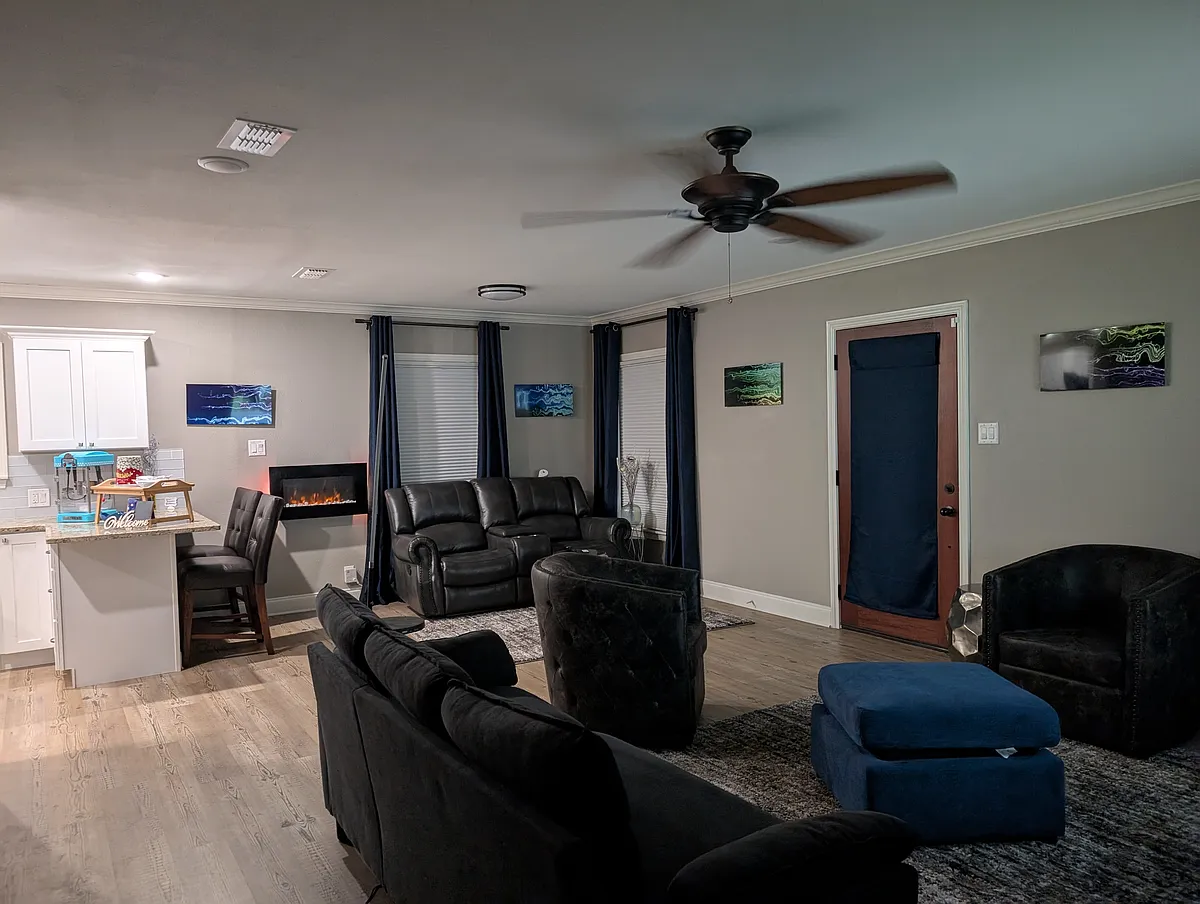 Cozy living area with conversation, dining, and TV spaces. Dinner and movie, anyone? - 921 Troup Hwy