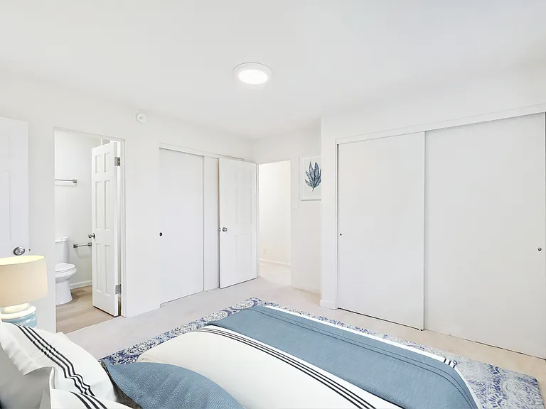 Primary bedroom showing en suite bathroom and 2nd closet on left.