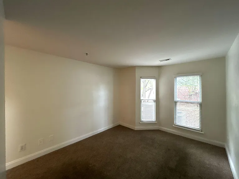Each bedroom is generously sized, carpeted, and features a private en-suite full bathroom and a spacious closet, providing comfort and privacy.