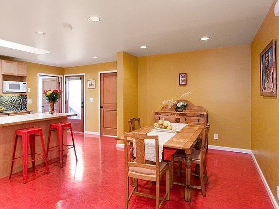 Who doesn't like to hang out in the kitchen? Love the red linoleum floors and it's all freshly painted.