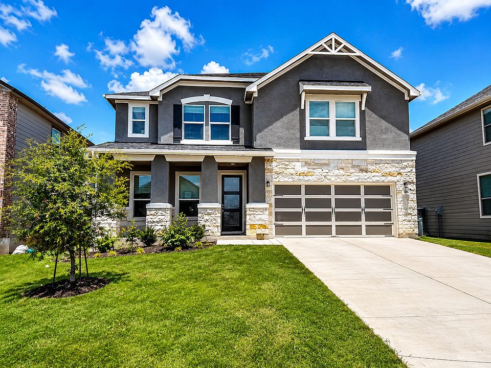 Front of house with enough room to park 4 cars in the driveway!