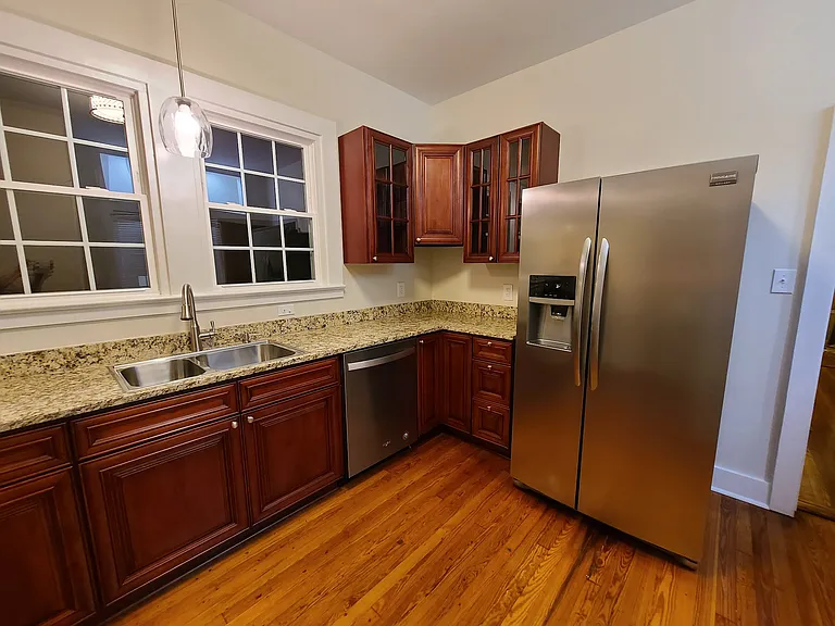 Kitchen w/ new cabinets, granite counters, electric ss stove/oven, ss overhead stove light/vent, ss dishwasher, ss double sink, garbage diposal, and ss french door refrigerator.