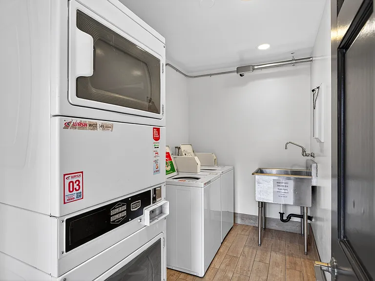 Laundry Room, featuring two washers and stacked double dryer.