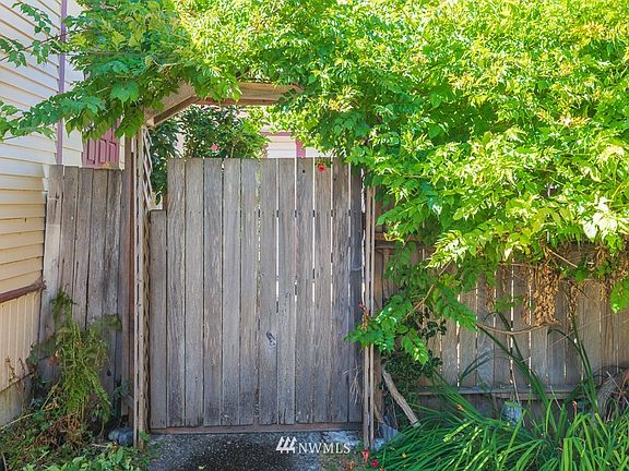 Arbor over aggregate concrete walkway.