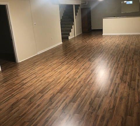 Giant basement with beautiful wood floors installed today! fabulous bar with mirror