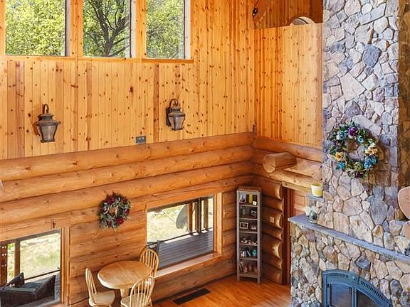 Great room with floor to ceiling stone fireplace. Downstairs is the master bedroom with en suite, another bedroom, full bath, mudroom and laundry room. Basement is great for storage.