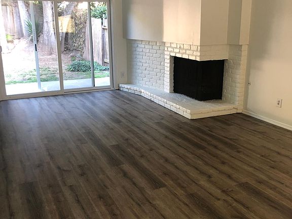 Living room with fireplace and sliding glass door to fenced