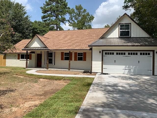 Street view, front porch and back porch ceilings are wood stained to match the shutters and front door. The yard had to be regraded and sodded after the new driveway was installed. Space up by the porch will have low maintenance plantings.