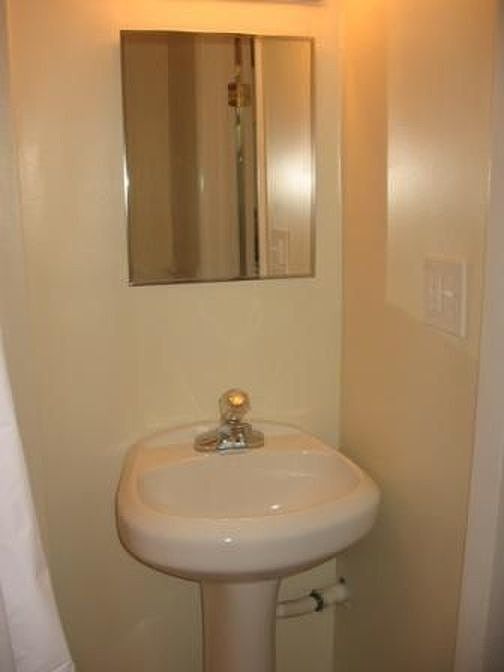Bathroom sink - plentty of storage in medicine cabinet and a