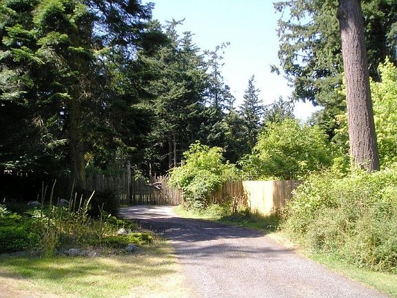 A gated entrance welcomes you to your private oasis! Over an acre of lush greenery...fully fenced. No deer or rabbits! Great for gardening and landscaping