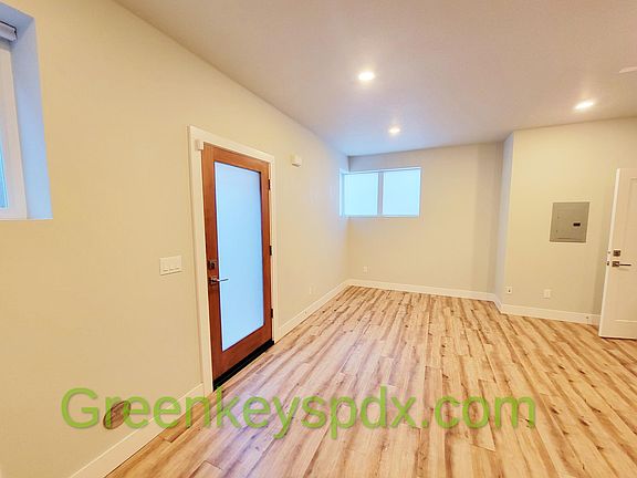 Inside the huge living room with new flooring and fresh paint
